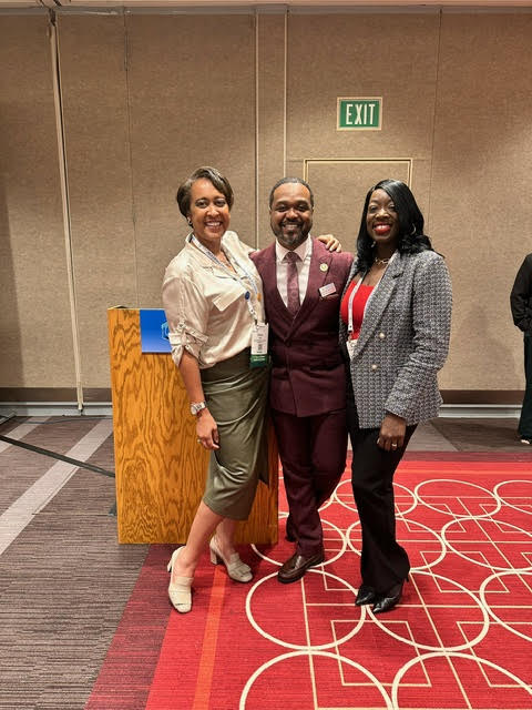 A group of people post together at the APHA 2024 workshop titled, "Committing to Equity: The Path Forward in Turbulent Times".