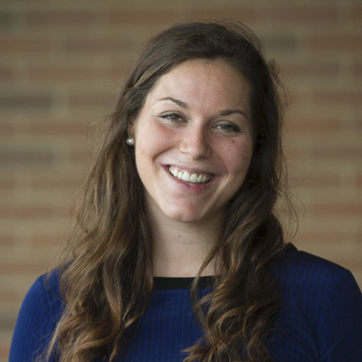 a person with long brown hair in a navy shirt 