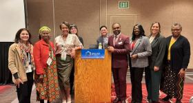 A group of speakers and participants posing together at the APHA Annual Meeting workshop.